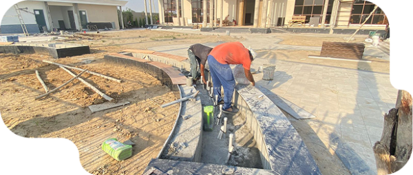 Workers completing exterior paving at a commercial construction site in Ludhiana